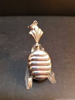 Front view of ribbed sterling perfume bottle pendant on stand