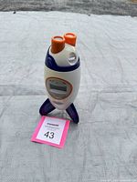 Front angled view showing overall rocket clock design and color scheme