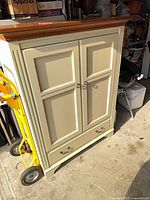 Front view of Ethan Allen ivory cabinet with doors and drawer