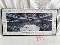 Front view of framed panoramic print showing arena scene and signatures