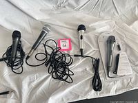 Overview of four wired microphones including one sealed package