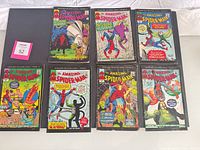 Seven Amazing Spider-Man reprint comics laid out on black background