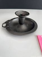 Overall view of pewter chamber candlestick with handle