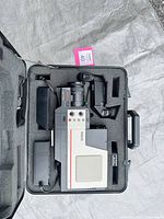 Open carrying case displaying camcorder, accessories and foam insert