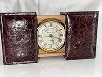 Clock front with case open showing dial