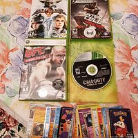 Overview of all game cases, Call of Duty disc, and spread of Pokémon cards