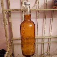 Full view of amber glass bottle on shelf