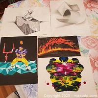 Overview of all five unframed artworks displayed on table