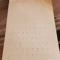 Full view of cut-paper artwork showing geometric pattern