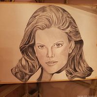 Full view of portrait drawing in wooden stretcher showing woman's face and flowing hair