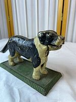 full side view of cast iron dog nutcracker on base