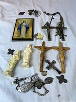 Group shot of entire lot showing crucifixes, Mary statues, plaque, medals and rosary