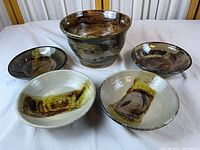 Group shot large bowl with four shallow bowls