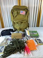 Full view of backpack with survival items laid out