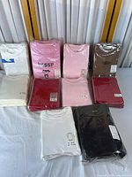 All ten packaged infant shirts displayed in two rows