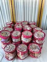 Group of sealed pink-trim cylindrical packs of girls briefs