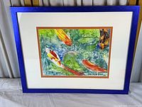 Full view of framed painting showing artwork, mats and blue frame