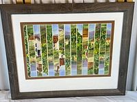 Front view of framed segmented countryside painting