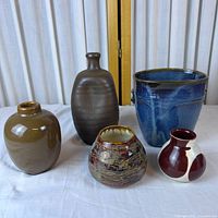 group shot of five handmade pottery pieces