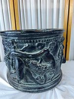 Full exterior view showing cherub relief and patinated surface