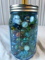 Overall view of blue Ball mason jar filled with marbles