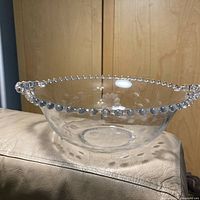 Side view of clear Cornflower glass bowl showing bead rim and etched flower base