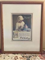 Full view of framed advertisement showing frame, mat, and print