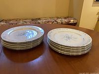 Stacked view of two sets of six dinner plates on table