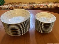 Stack of 12 soup bowls next to stack of 12 dessert bowls