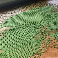 Close-up of green crocheted doily mesh and lattice edge
