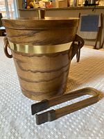 Wood exterior ice bucket with lid and tongs, brass-tone band visible