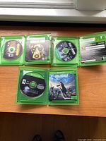 Open cases showing game discs: Borderlands, Rainbow Six Siege, Final Fantasy XV