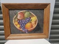 Framed still life painting with fruit bowl