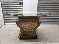 Full view of pedestal table showing base and glass top