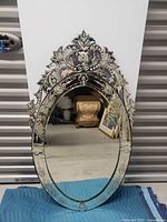 Front view of ornate oval etched glass mirror