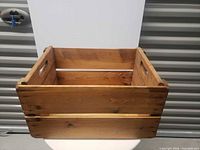 Front view of pine crate showing slats and grain