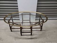 Full view of oval glass coffee table, glass top and base visible