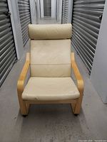 Front view of beige Ikea Poäng armchair showing full frame and upholstery