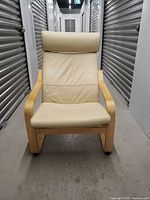 Front view of Ikea bentwood armchair, beige faux leather cushion, full chair visible