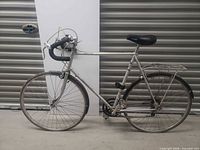 Full left side view of Panasonic Sport-500 bicycle showing frame, wheels, handlebars and rear rack