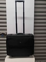 Front view of Solo black wheeled travelers case with extended handle