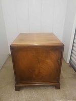 Front angled view of wooden cabinet