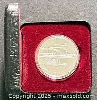 Coin in red-velvet lined clamshell case