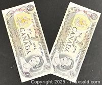 Obverse of both 1973 $1 banknotes showing Queen Elizabeth II and serials