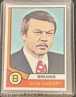 Front of 1974-75 O-Pee-Chee Don Cherry rookie card showing portrait and Bruins details in plastic sleeve