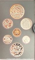 Obverse designs of seven proof coins in holder