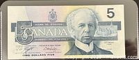 Front of 1986 Canada $5 banknote showing portrait of Sir Wilfrid Laurier and large numeral 5