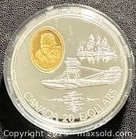 Reverse showing gold-plated cameo, seaplane and schooners with denomination