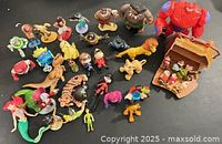 Overview of full assortment of Disney figurines and treasure chest