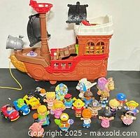 Group shot showing pirate ship with all figures and vehicles in front